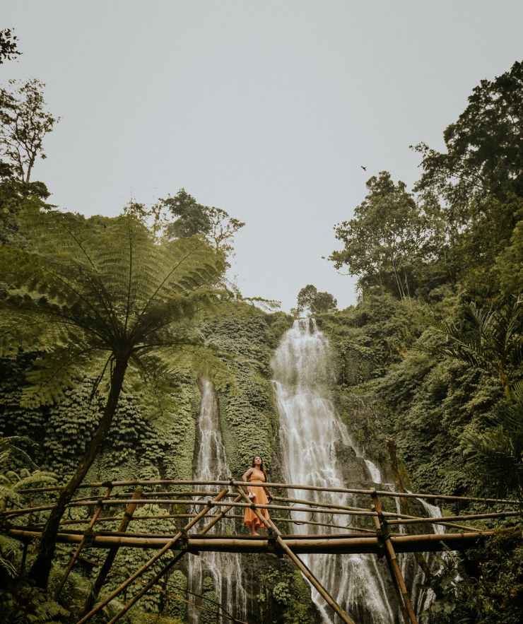 photo of woman standing on bridge